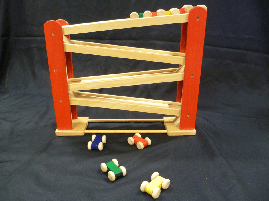 A five level track with four single cars and one three carriage train. The car or train can be placed at the top to run down the track.