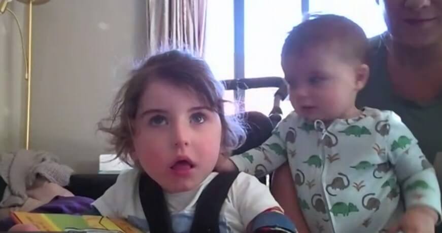 Child sibling and parent looking into the camera