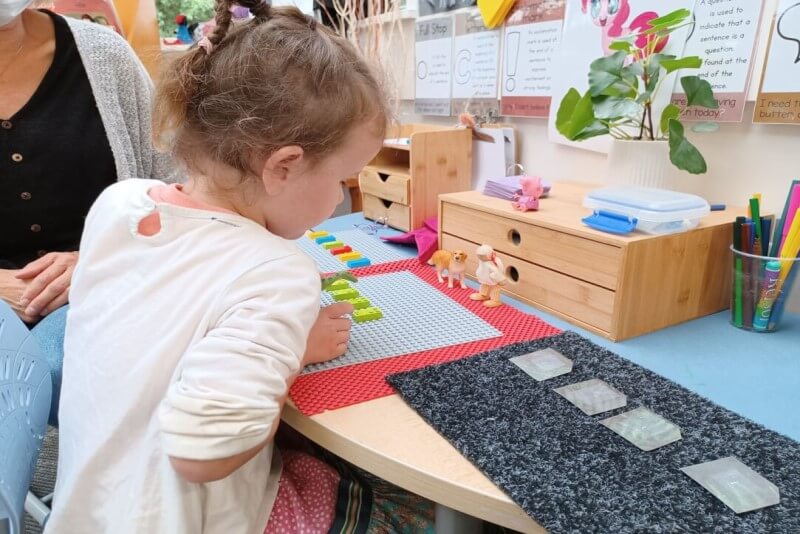 Lily playing with braille lego bricks
