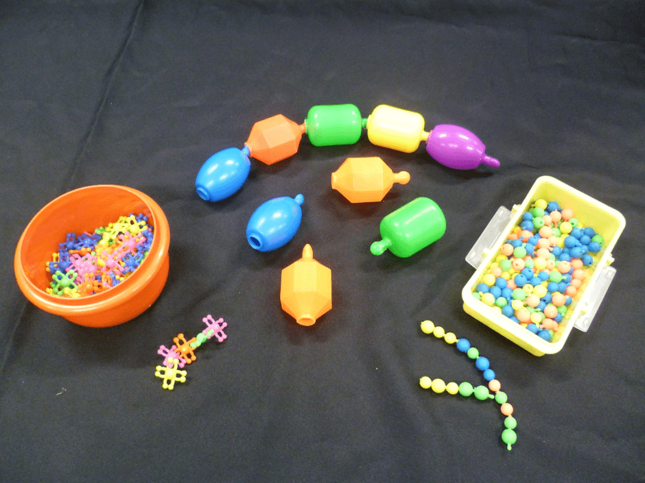 Three varieties of pop beads of different sizes.