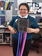 Te Ngaru is standing up showing her finished Matariki day kite