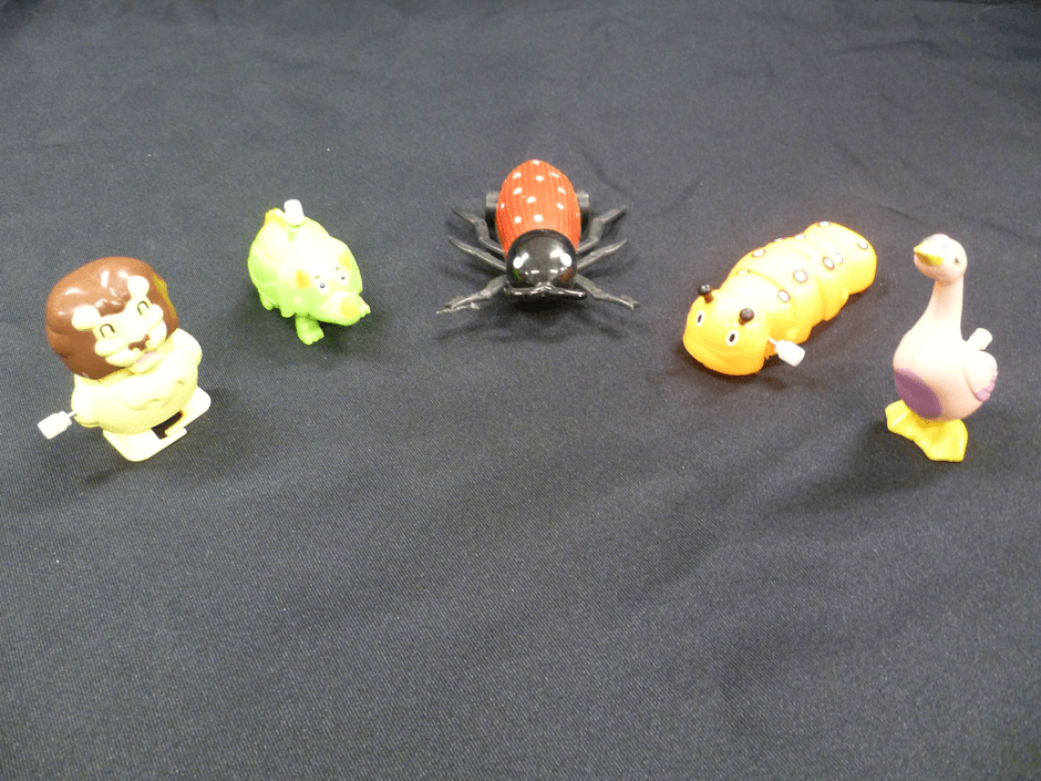 Five plastic wind up toys.